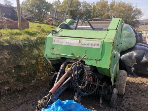Round baler for sale it is working but missing a spring for banding